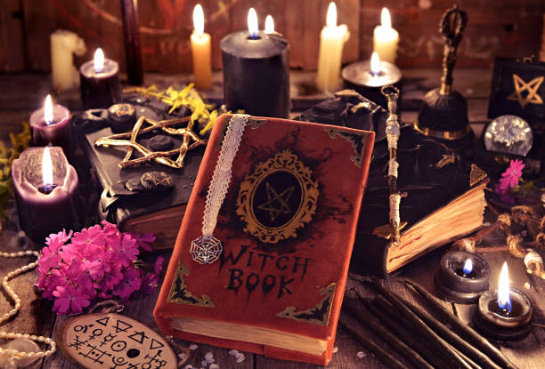 istock Witch books, black candles with magic and mystic objects on planks 970620334