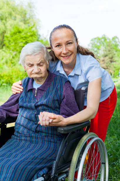 istock Handicapped woman with caretaker 970643910