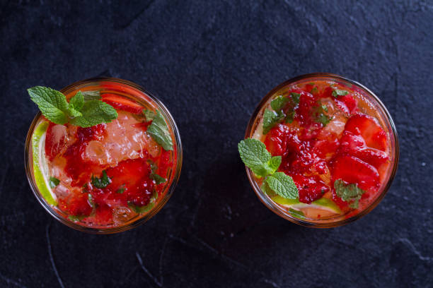 istock Strawberry mojito cocktail with berries, lime, mint and ice, black background 970651656