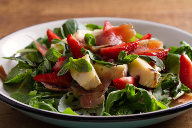 istock Strawberry, basil, mint, arugula salad with brie cheese and jamon 970654794