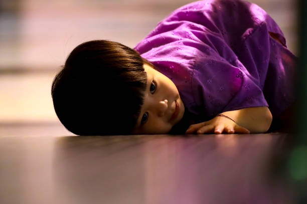 Portrait of a lovely asian girl lying on the floor