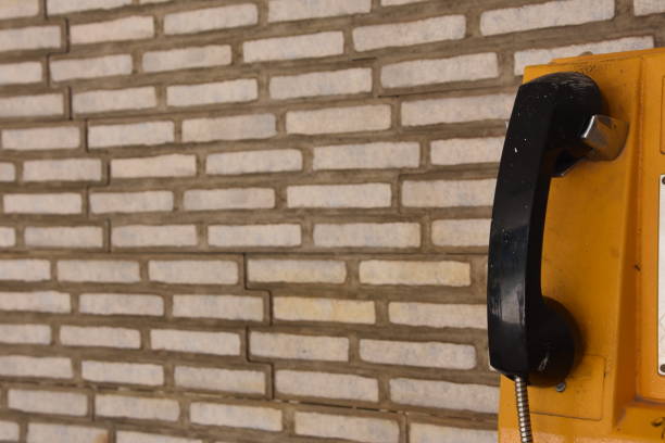 istock A public telephone set against a brick wall 970669818