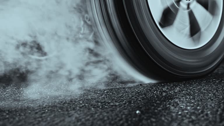 Car tyre rotating in place and smoking