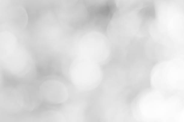 istock white blurred backdrop of nature, circle white wallpaper, gray bokeh background 970676568