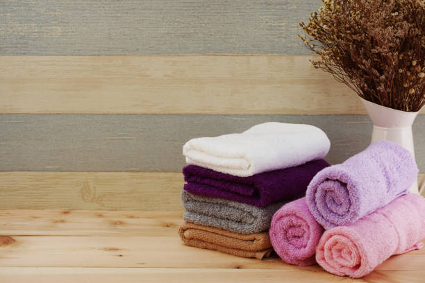 istock spa towels with space copy on wooden background 970688856