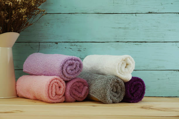 istock spa towels with space copy on wooden background 970689602