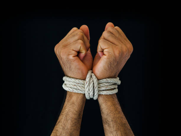 istock Man hands were tied with a rope. Violence, Terrified, Human Rights Day concept. 970715036