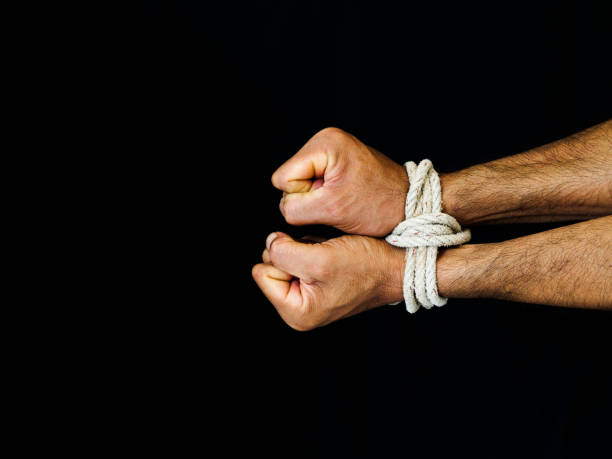 istock Man hands were tied with a rope. Violence, Terrified, Human Rights Day concept. 970715064