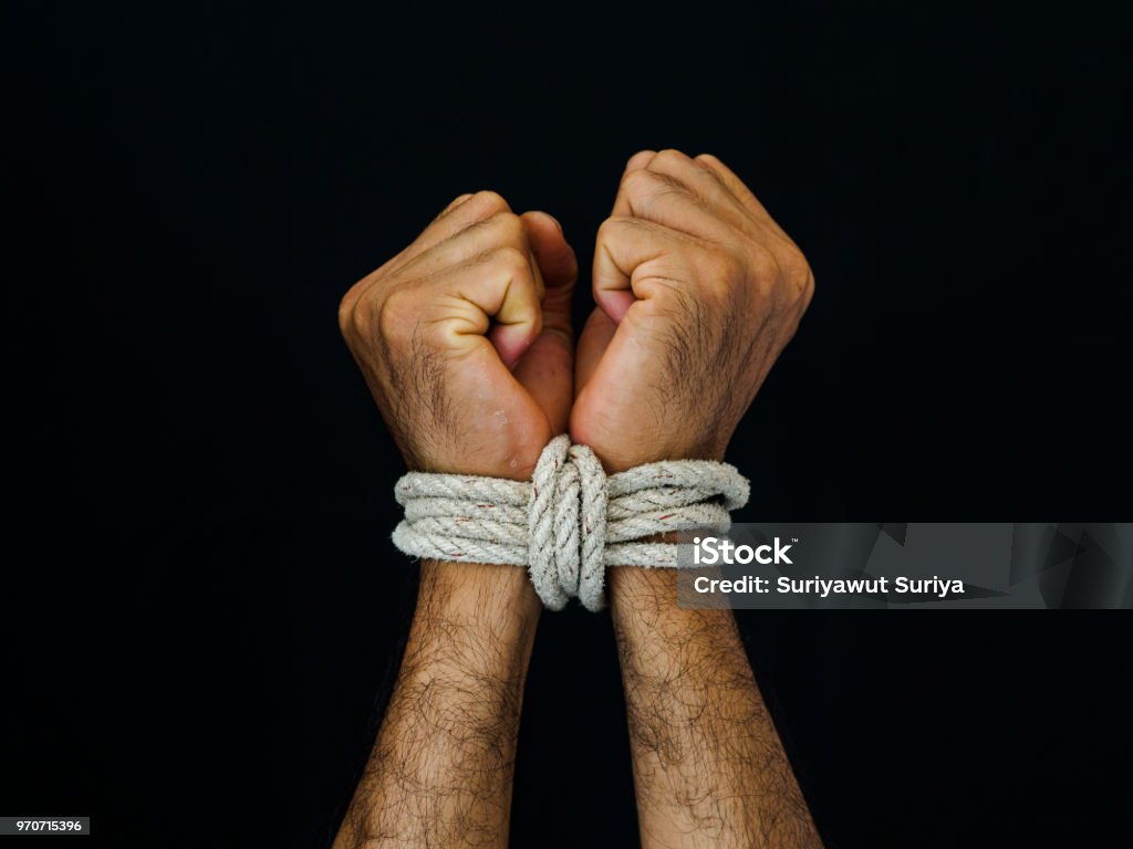 Man hands were tied with a rope. Violence, Terrified, Human Rights Day concept. Tied Up Stock Photo