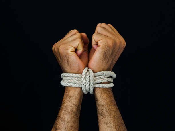 man hands were tied with a rope. violence, terrified, human rights day concept. - tied up imagens e fotografias de stock