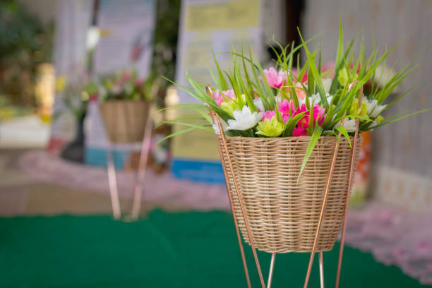 Artificial floral arrangement as a centerpiece on a crochet tablecloth.
