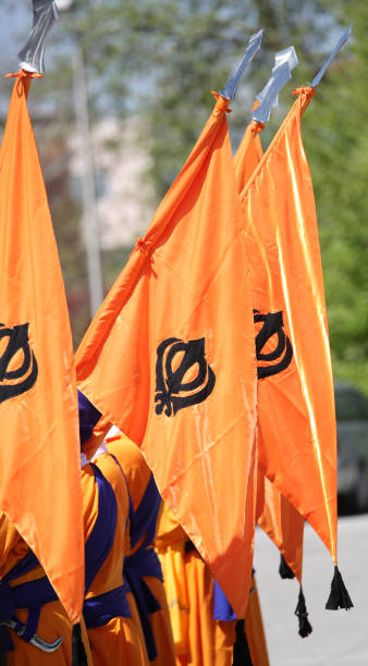 istock orange sikh flags with khanda symbol during a religiuous process 970740524