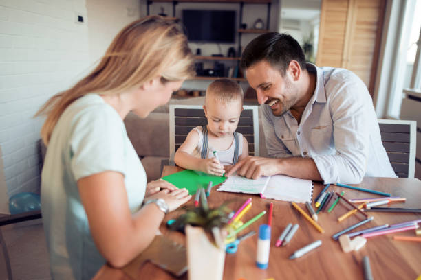 istock Mom and dad drawing with their son 970744550