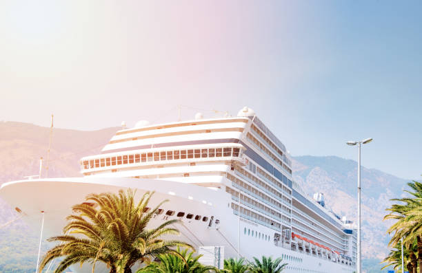 Cruise ship. Large luxury white cruise ship liner on sea water and cloudy sky background. Montenegro, Kotor stock photo