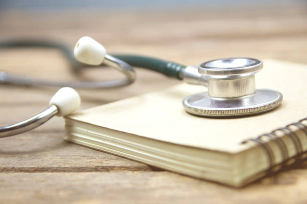 istock Medical stethoscope with notebook on wooden desk 970752490