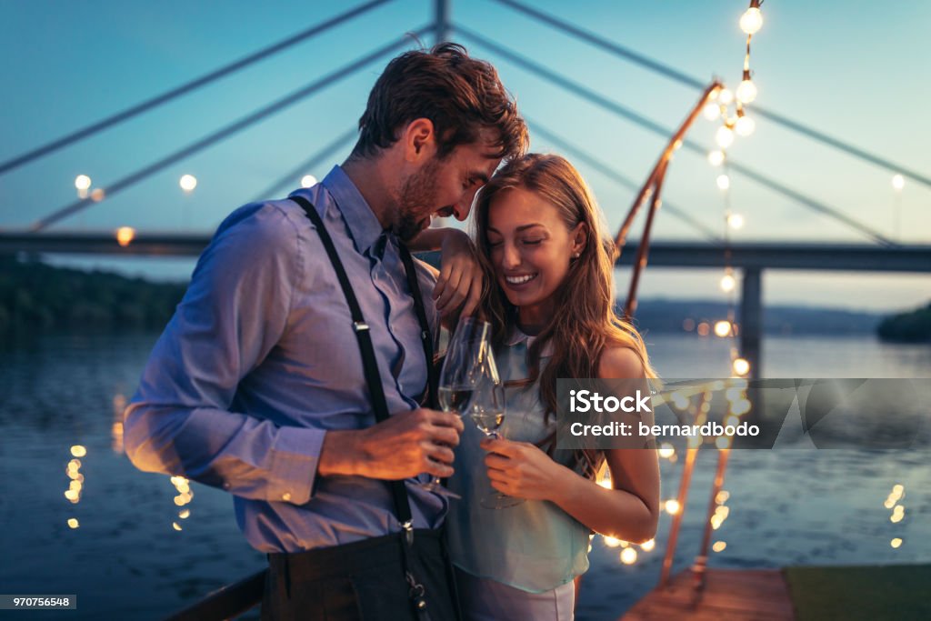 I'm totally stuck on you Shot of young affectionate couple on a boat cruise Flirting Stock Photo