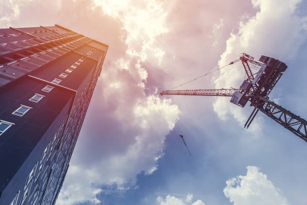 istock construction crane and hight building condominium against the blue sky 970756894