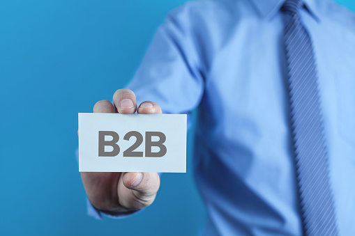 Businessman showing B2B word on business card.