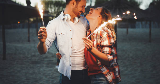 istock Group of happy friends having fun on beach at night 970763460
