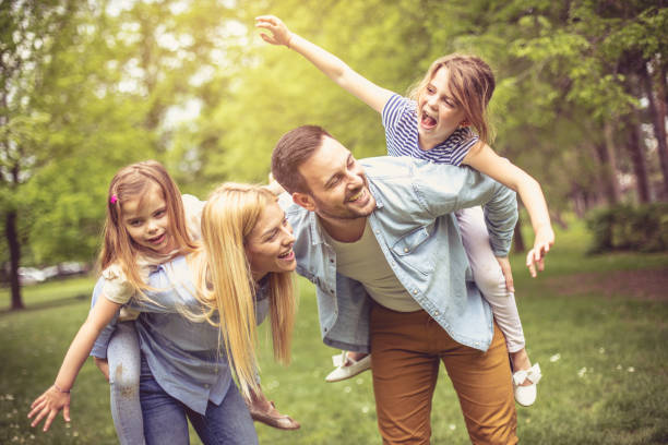 istock Happy parents with daughter at park. 970768836