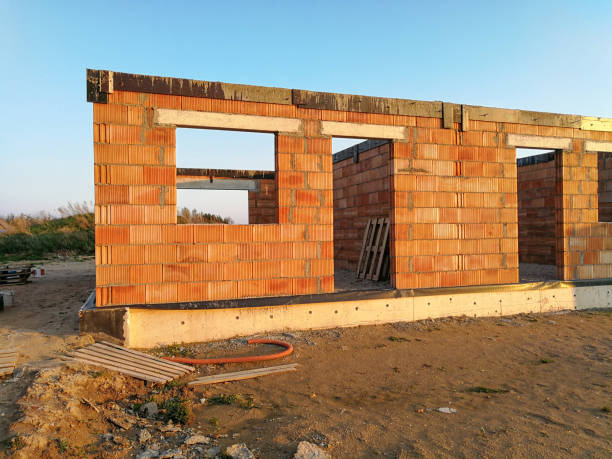 istock Unfinished modern cottages constructed from blocks during evening 970775472