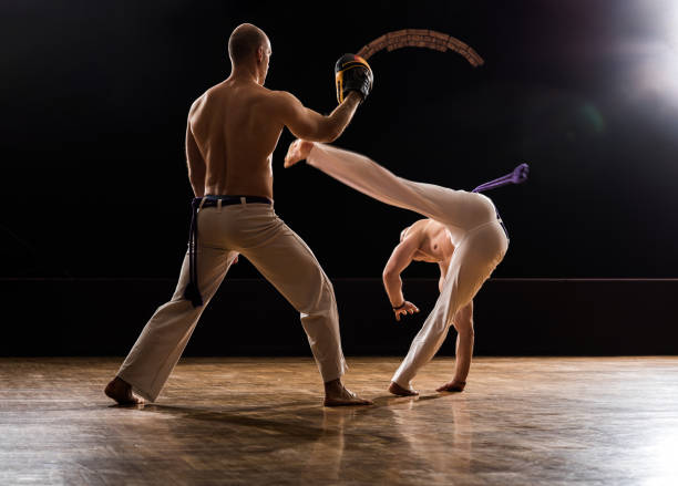 istock Exercising capoeira moves on sports training! 970784460