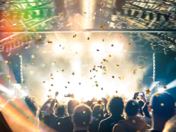 istock Concert hall with a big stage and many fans 970788618