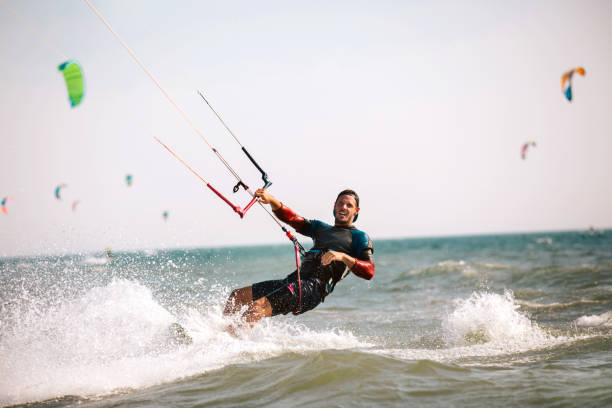 istock Athletic man riding on kite surf board 970788644