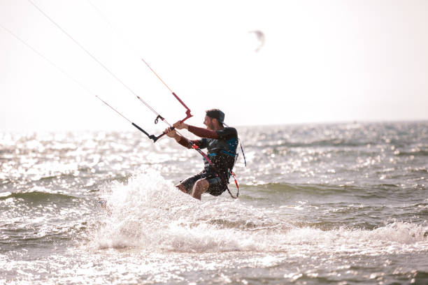 istock Athletic man riding on kite surf board 970789208