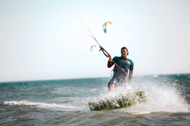 istock Athletic man riding on kite surf board 970789210