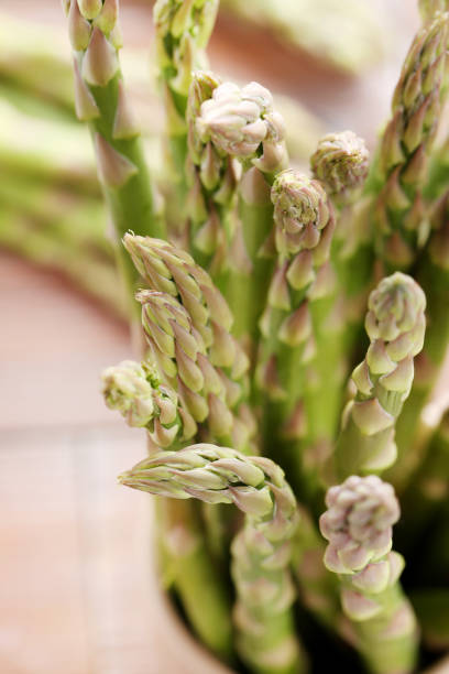 istock Green asparagus on brown wooden table 970790376