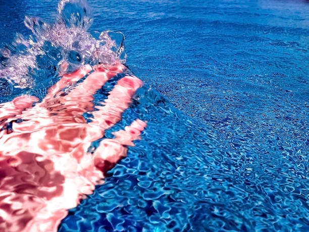 istock Crop hand under splash of water 970792392