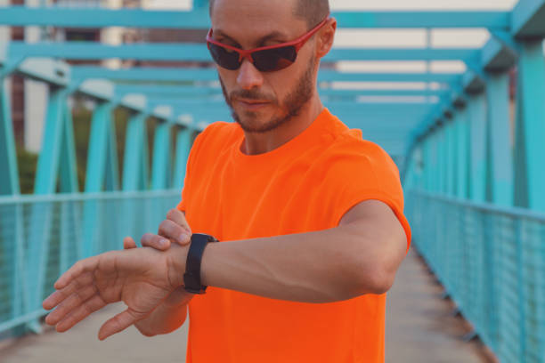 istock Checking the time after exercising / jogging outdoors. Optical focus is on the hand and watch. 970795452