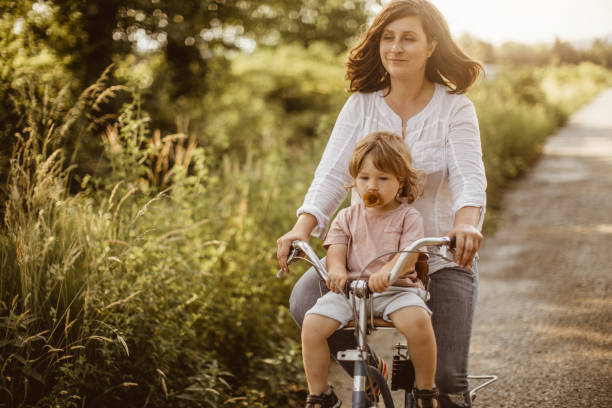 istock Mother Cycling With Her Son in Nature 970795454
