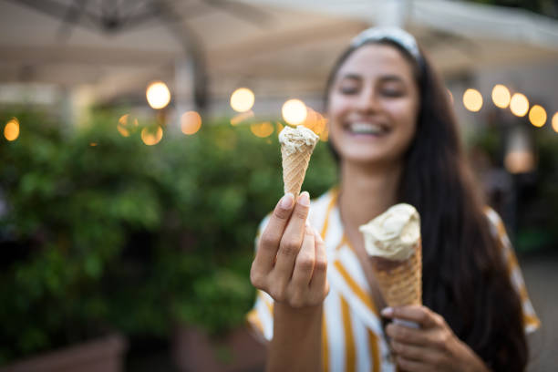 istock Smiling woman holding icecream. 970798694