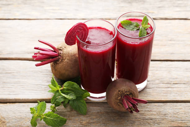 istock Fresh beets juice in glass on grey wooden table 970799008