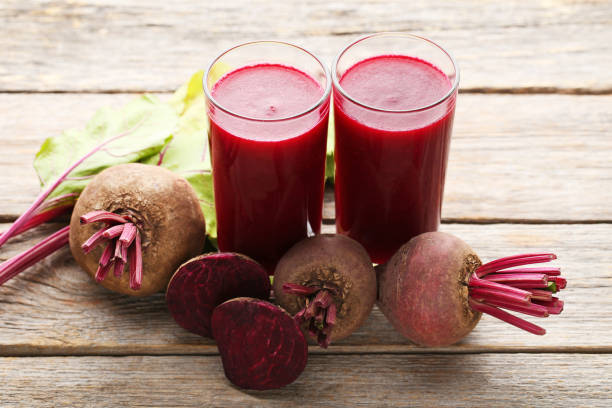 istock Fresh beets juice in glass on grey wooden table 970799866