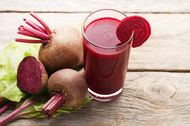 istock Fresh beets juice in glass on grey wooden table 970802680