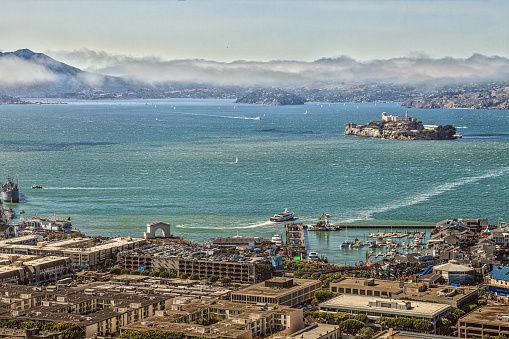 San Francisco, California, United States - August 14, 2016: Aerial view of Alcatraz Island, Hyde Street Pier in Fisherman's Wharf and Maritime National Historical Park, from top of Coit Tower.