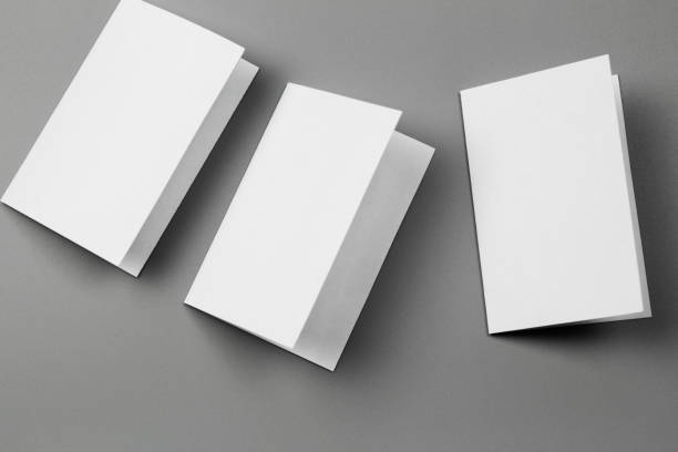 istock Blank portrait mock-up paper. brochure magazine isolated on gray, changeable background / white paper isolated on gray 970819002