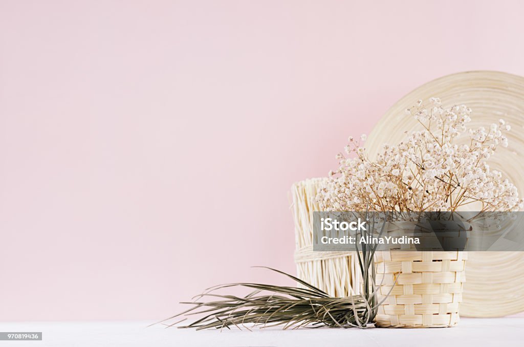 Small White Dried Flowers In Beige Wicker Basket And Wooden Decor
