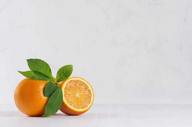 selective colorful oranges with green foliage on white modern kitchen interior. - orange wall imagens e fotografias de stock