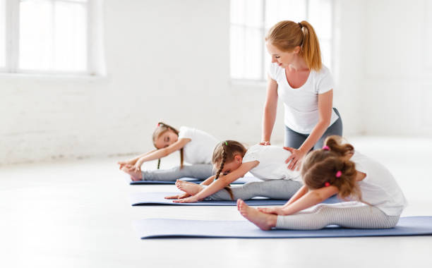 istock children practicing engaged in gymnastics and yoga with  teacher 970822484