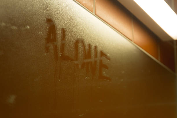 istock inscription text on sweaty wet glass - Alone 970823384