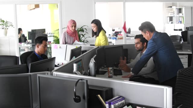 Multi ethnic group working in modern open plan office