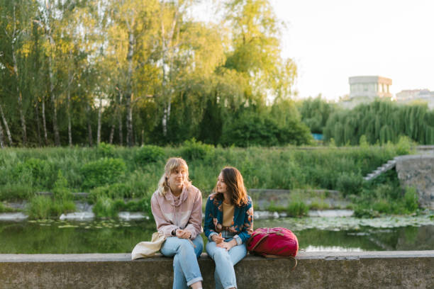 istock Two women talking near the river at sunset 970829280