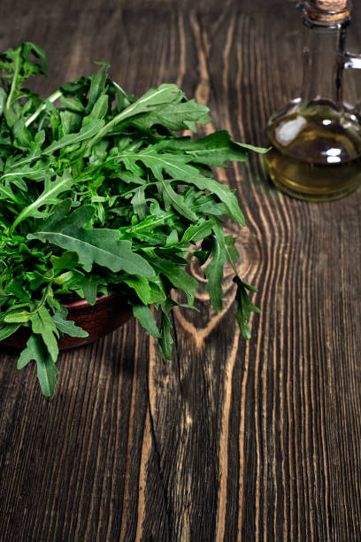 istock Fresh green arugula on wooden table 970832606