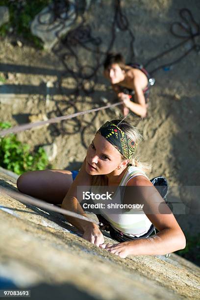 Downward View Of A Woman Rock Climbing With Friend Stock Photo - Download Image Now - Active Lifestyle, Activity, Adult