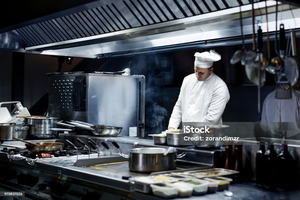 Chef working on the kitchen Commercial Kitchen Stock Photo