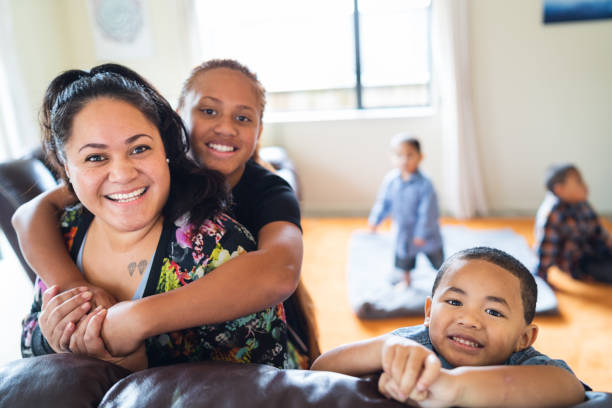 Maori mother with kids at home. stock photo